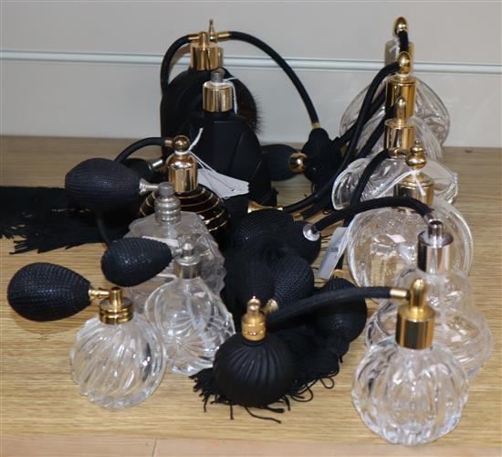 Five black glass and ceramic perfume atomisers and nine cut glass examples with black bulbs and tassels